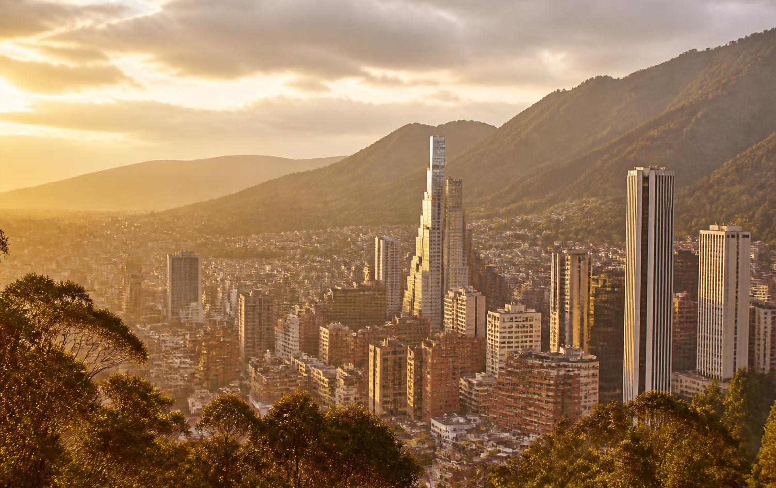 Bogotá skyline at golden hour with the Andes mountains behind it